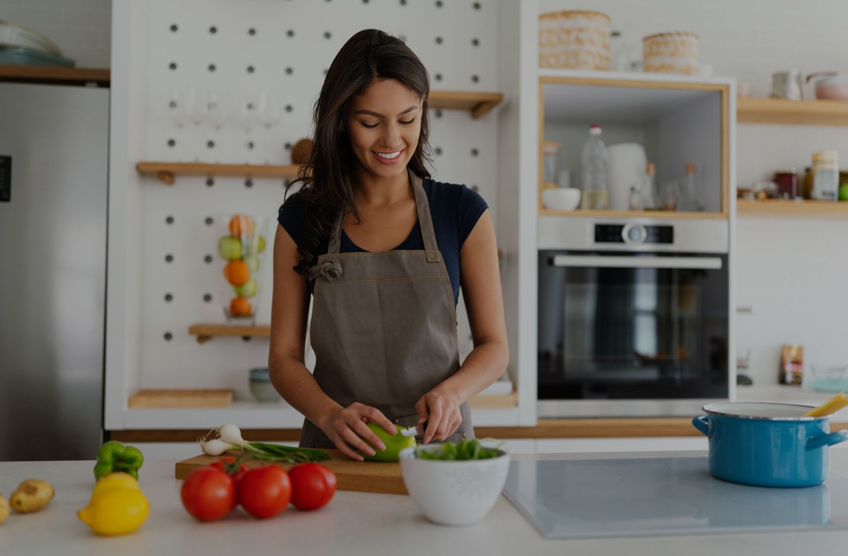 Woman preparing a healthy meal in kitchen for intermittent fasting lifestyle.