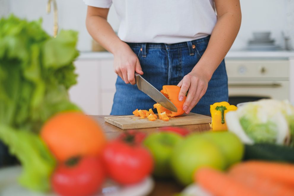 A Woman Cutting a Ripe Bell Pepper A Woman Is Cuttin A Bell Pepper