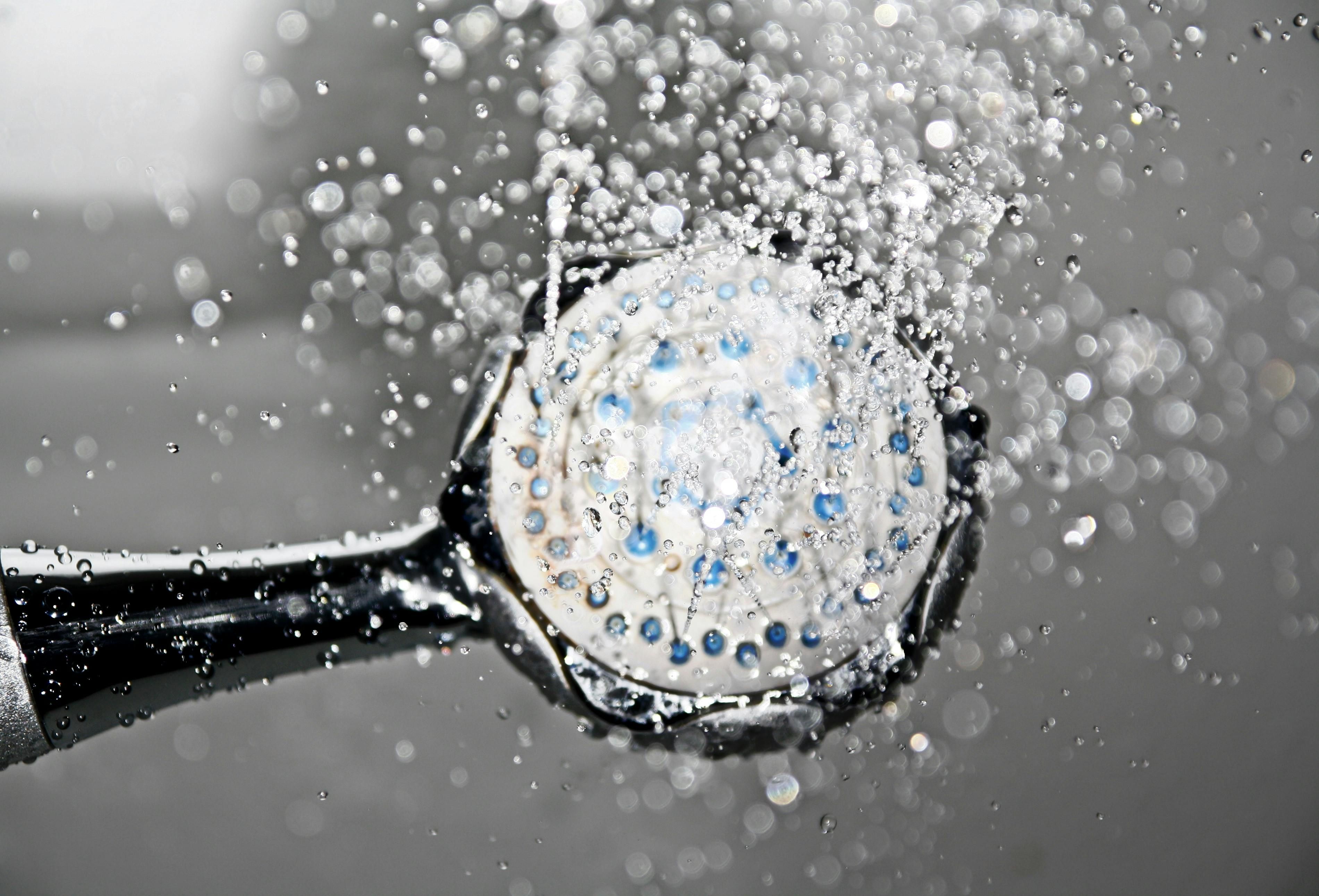 Cold Showers for Weight Loss: Boost Your Metabolism with Cold Exposure Cold water flowing from a showerhead, representing cold exposure techniques for weight loss.