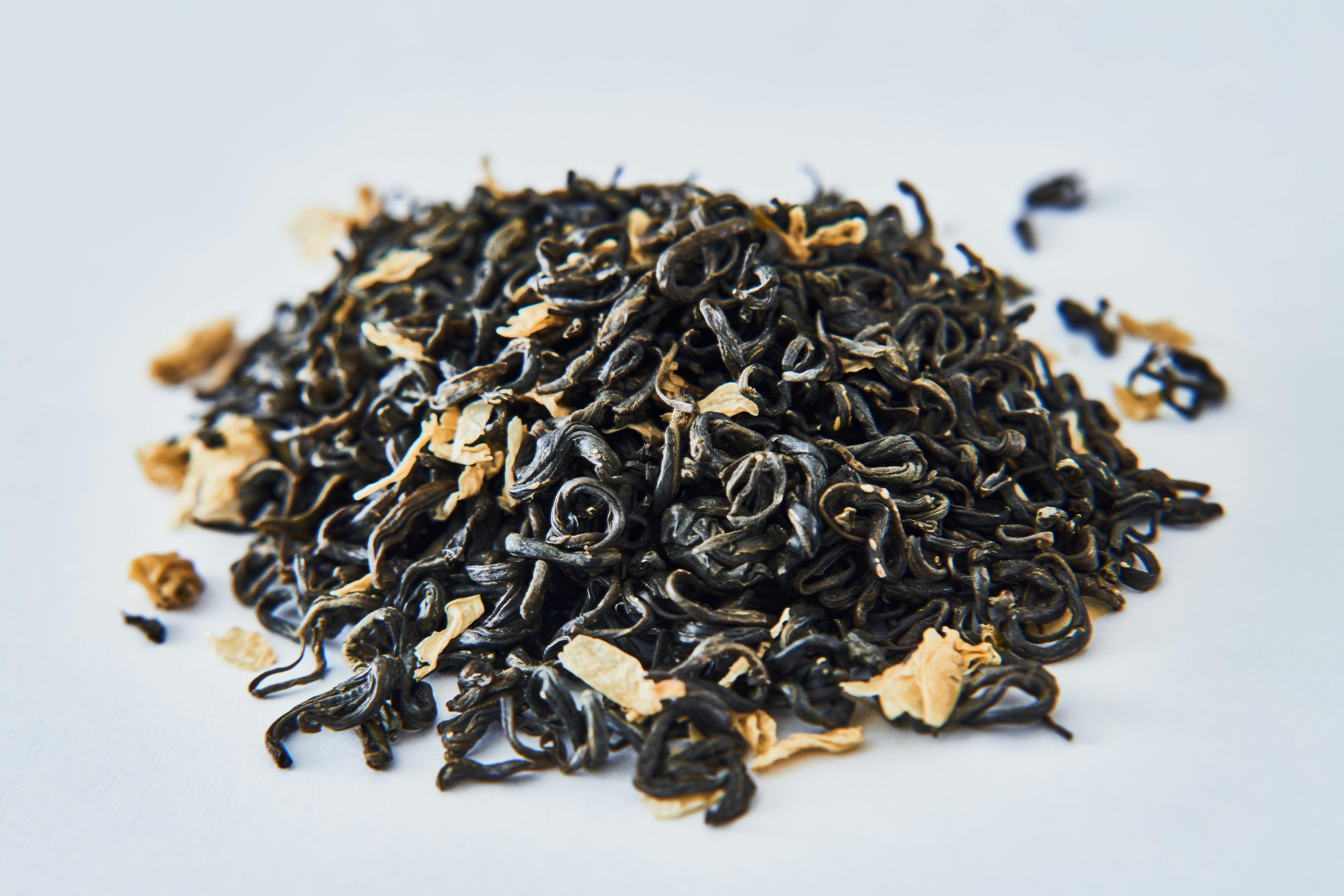Premium Black Tea Leaves: Friend or Foe During a Fast? A small wooden bowl filled with fragrant, high-quality dried black tea leaves - a tempting morning treat that may or may not break an intermittent fast