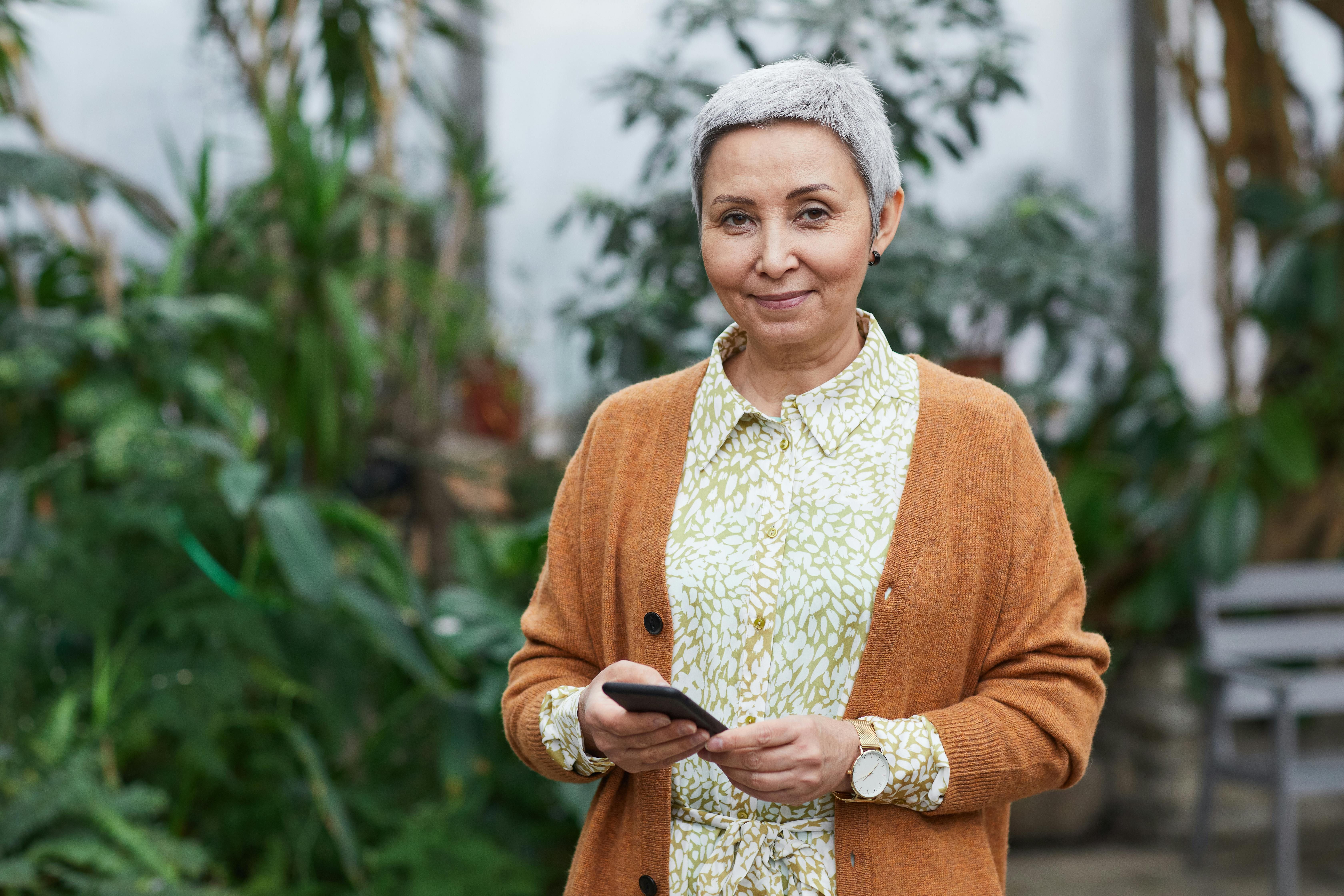 Elderly woman reviewing her fasting plan, highlighting the tailored approach to fasting for older women's health