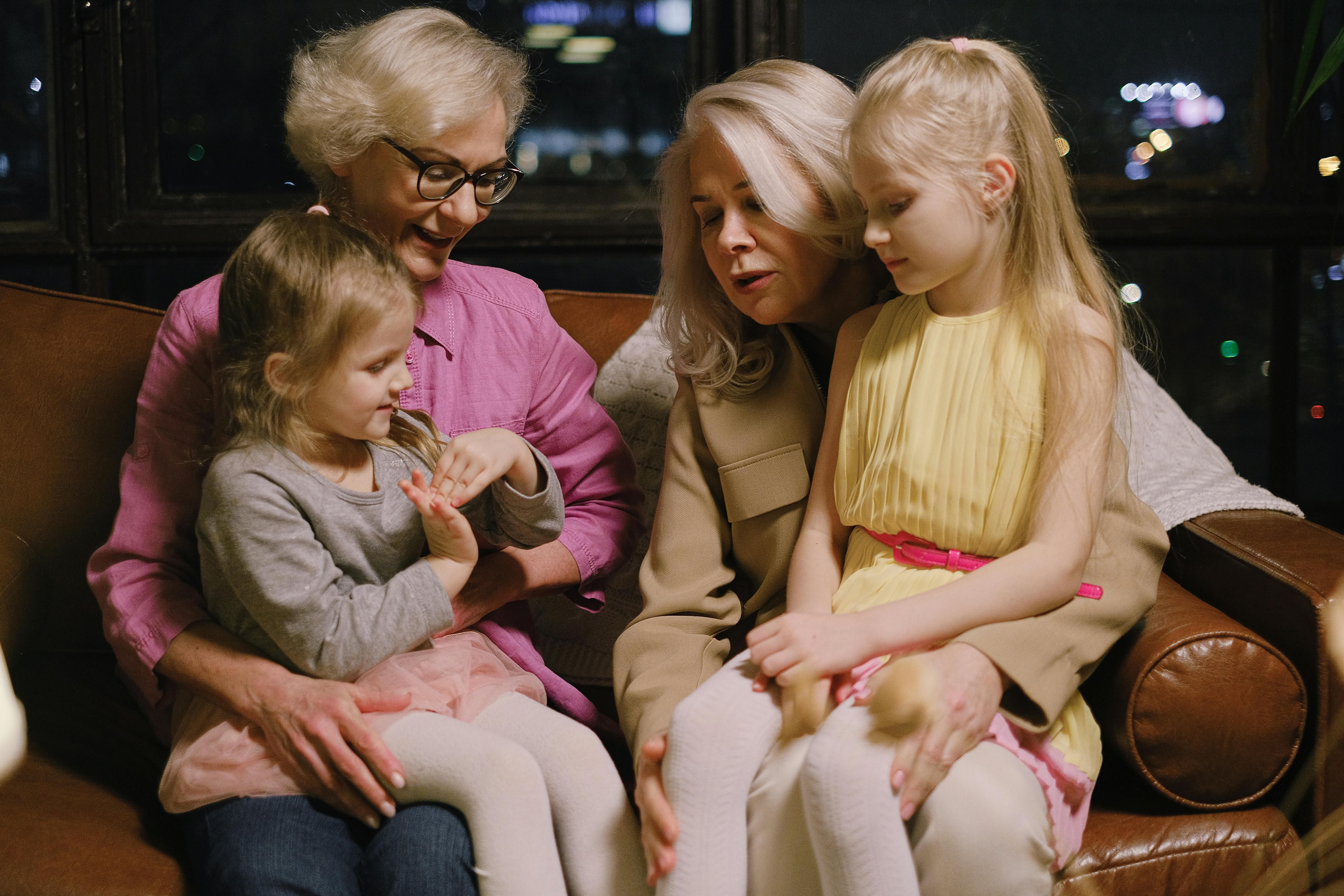 Joyful Moments: Women Over 60 Cherishing Time with Their Granddaughters Two happy women over 60 enjoying playful moments with their granddaughters, celebrating family and togetherness