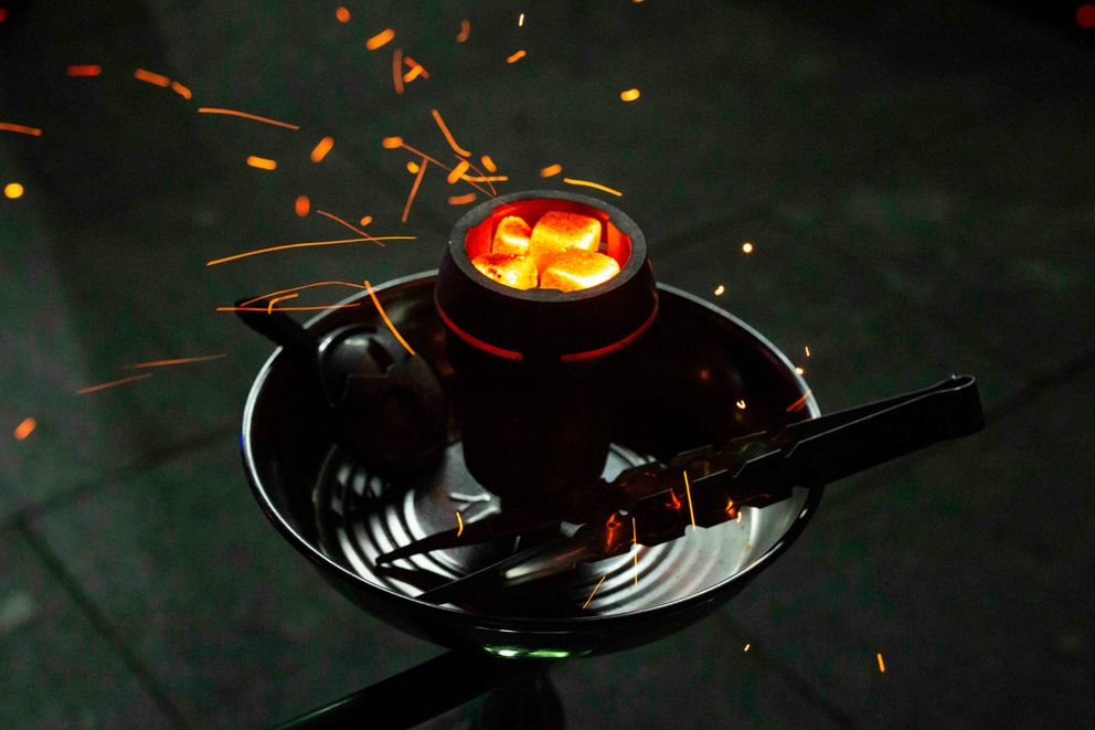 The Dangers of Using Hookahs for Women in 2024: Health Risks and Facts A woman experiencing the harmful effects of using hookahs, highlighting risks like respiratory issues, cancer, and infectious diseases.