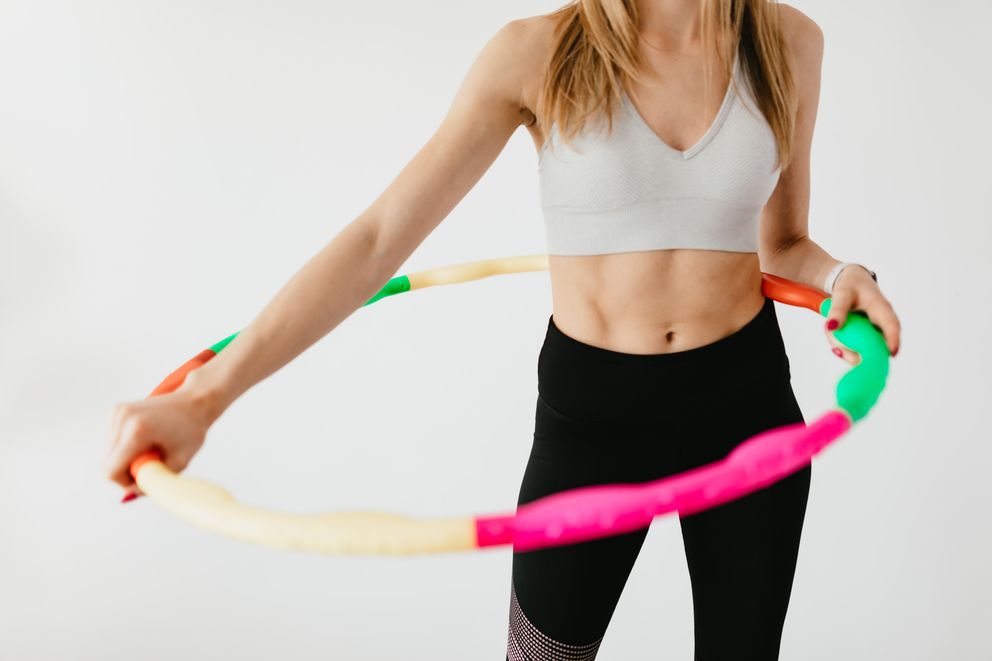 A Slim Woman Holding a Hoop to Lose Weight Fit woman with a hoop