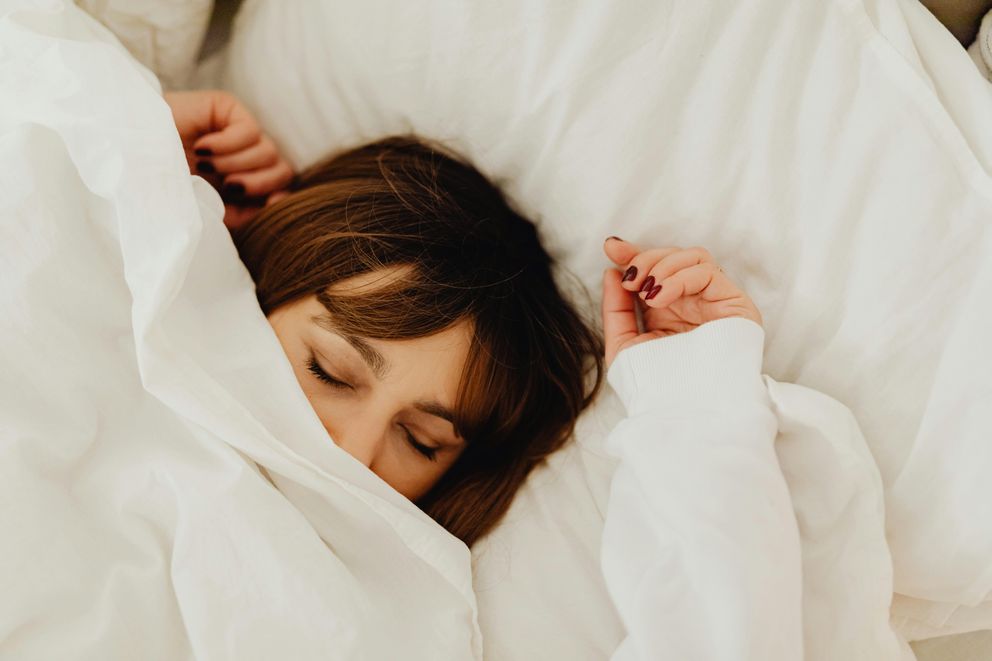 Optimizing Women's Sleep: Navigating Melatonin's Potential Woman enhancing sleep quality with melatonin supplementation