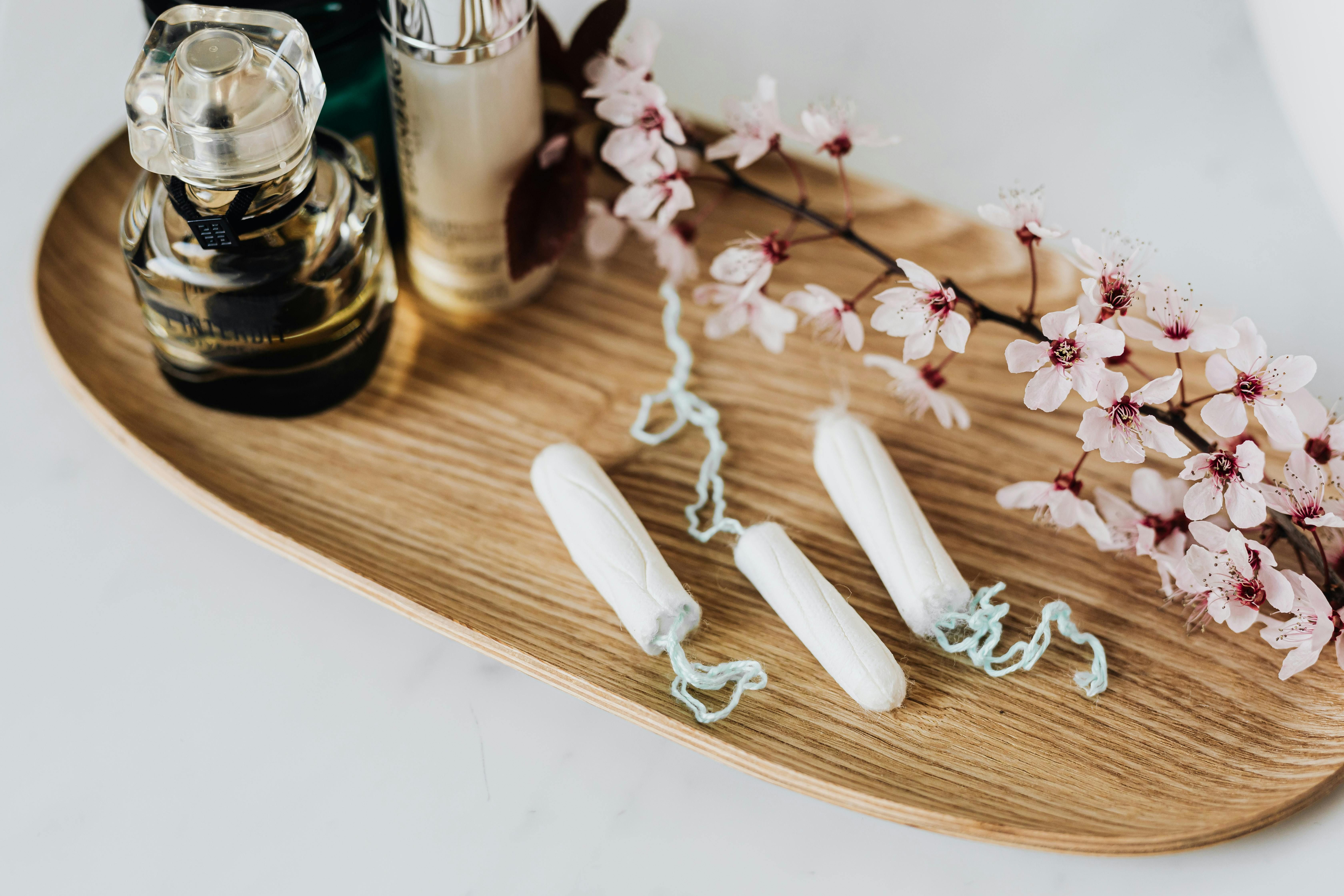 Managing Menstrual Health While Intermittent Fasting: Essential Hygiene Products Menstrual hygiene products on a table, supporting women's health during intermittent fasting