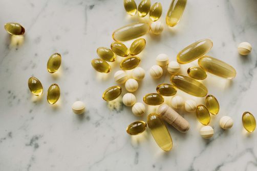Navigating Omega-3 Supplement Side Effects: A Closer Look Omega-3 supplement capsules and bottle on a surface