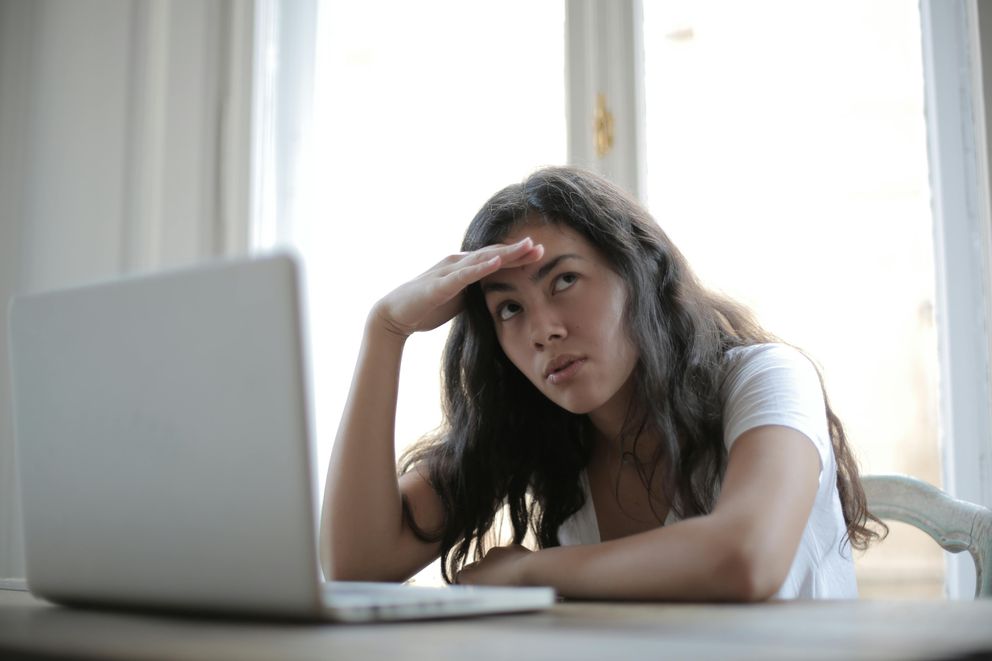 Young lady contemplating how to fight fatigue with the right supplements for energy boost Unlocking Energy: Woman Contemplates Fatigue-Fighting Supplements