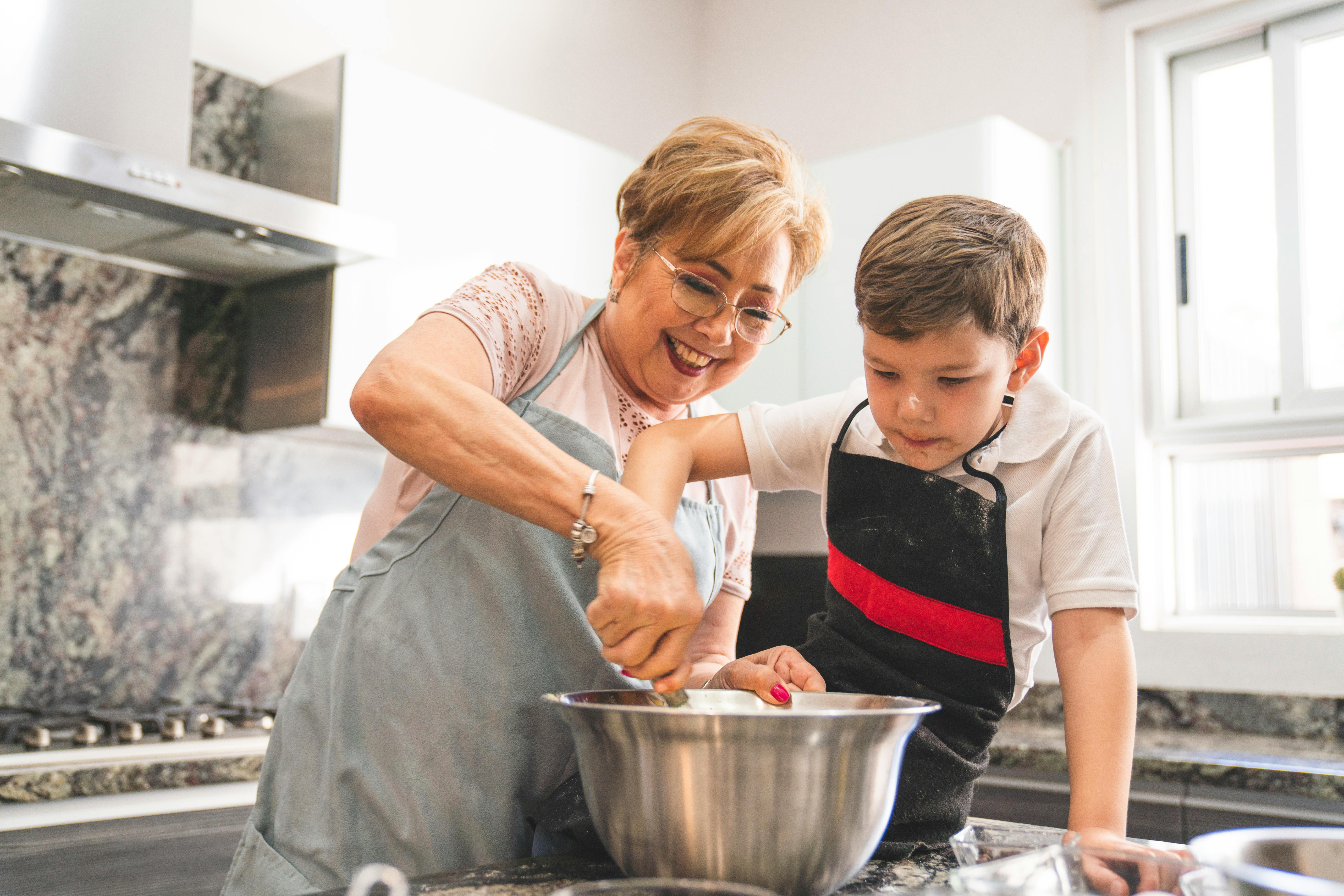 Grandmother and young grandson cooking together, bonding over a healthy meal during intermittent fasting eating window