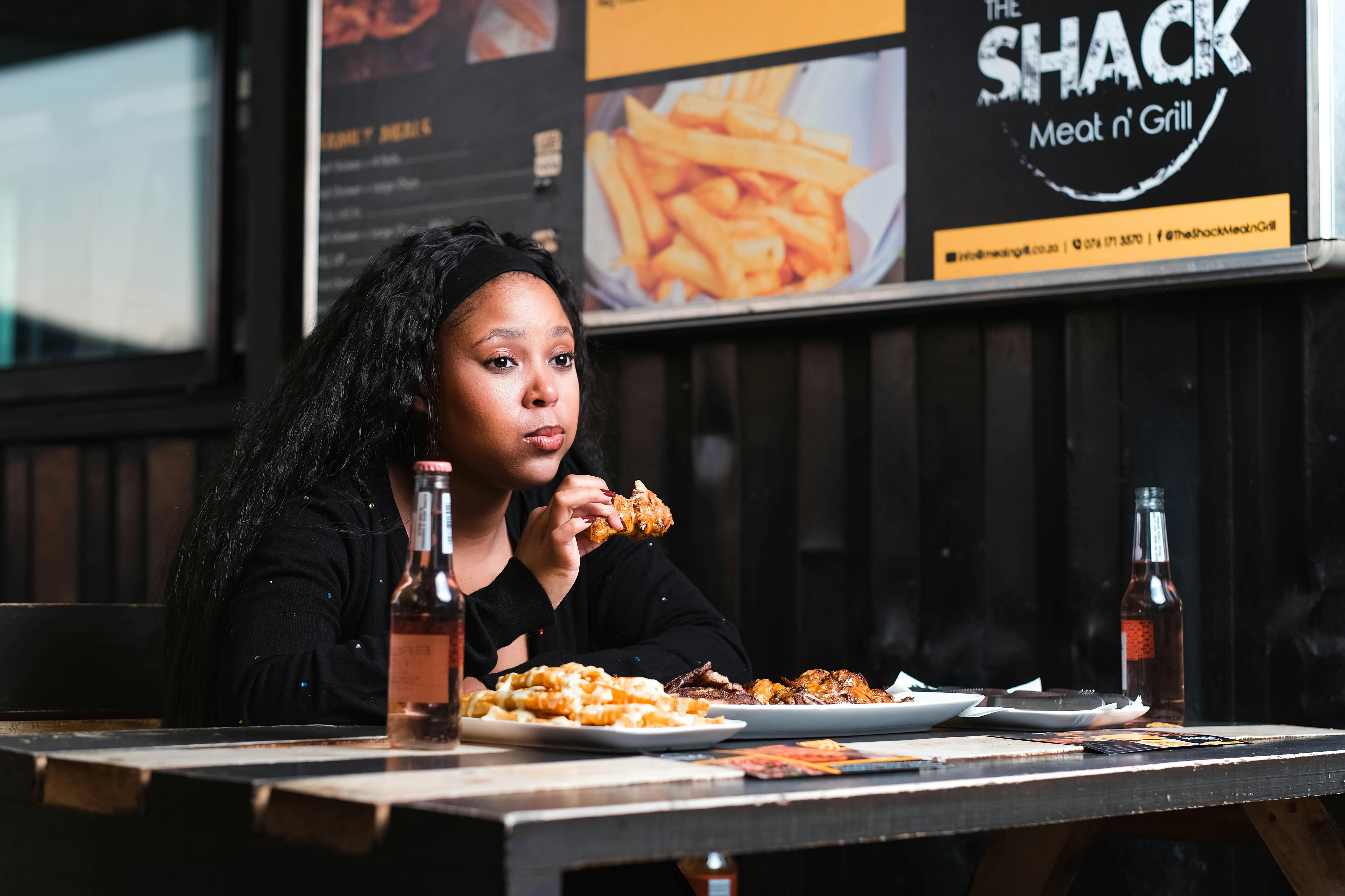 ADHD and Binge Eating: Understanding the Challenges A woman with ADHD binge eating, highlighting the challenges of impulsive eating behaviors associated with ADHD.