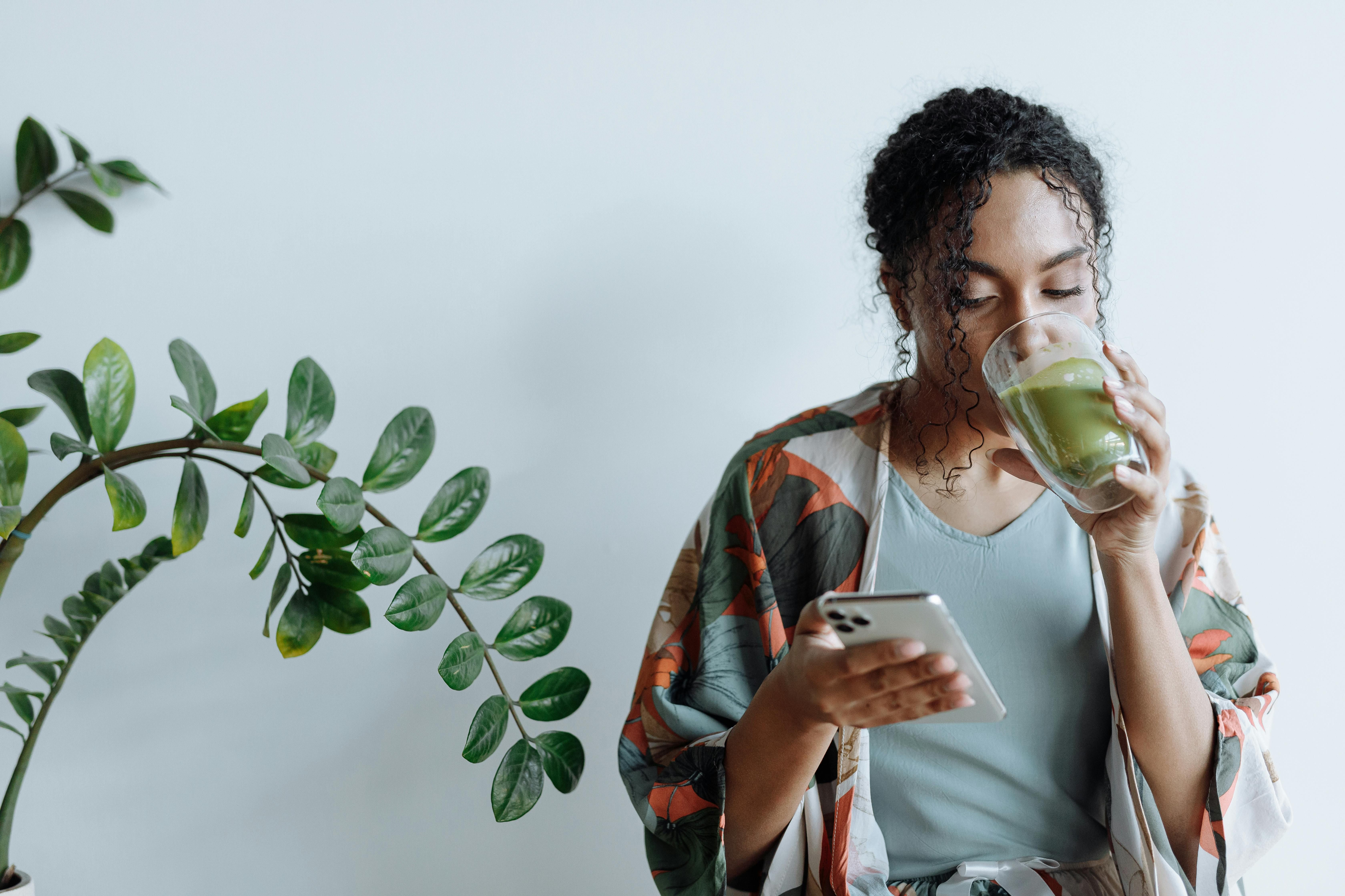 Woman Drinking Matcha Tea: Discover the Weight Loss Benefits and Health Advantages A woman enjoying a cup of matcha tea, promoting its benefits for weight loss and healthy living