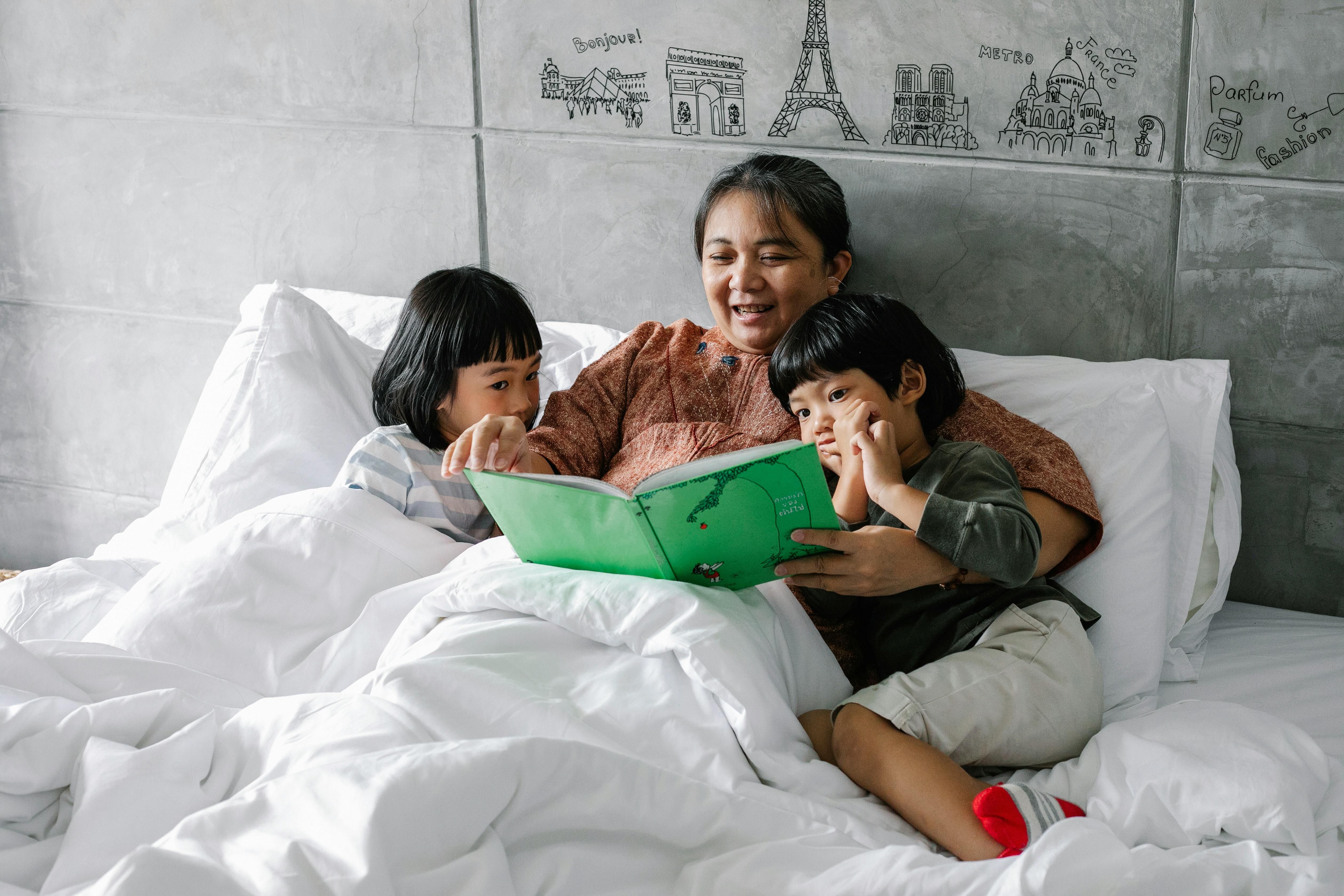Mother and Children Preparing for Sleep with a Relaxing Bedtime Routine in a Cozy Bedroom A woman preparing for sleep with her children in a cozy bedroom, creating a calming bedtime routine.