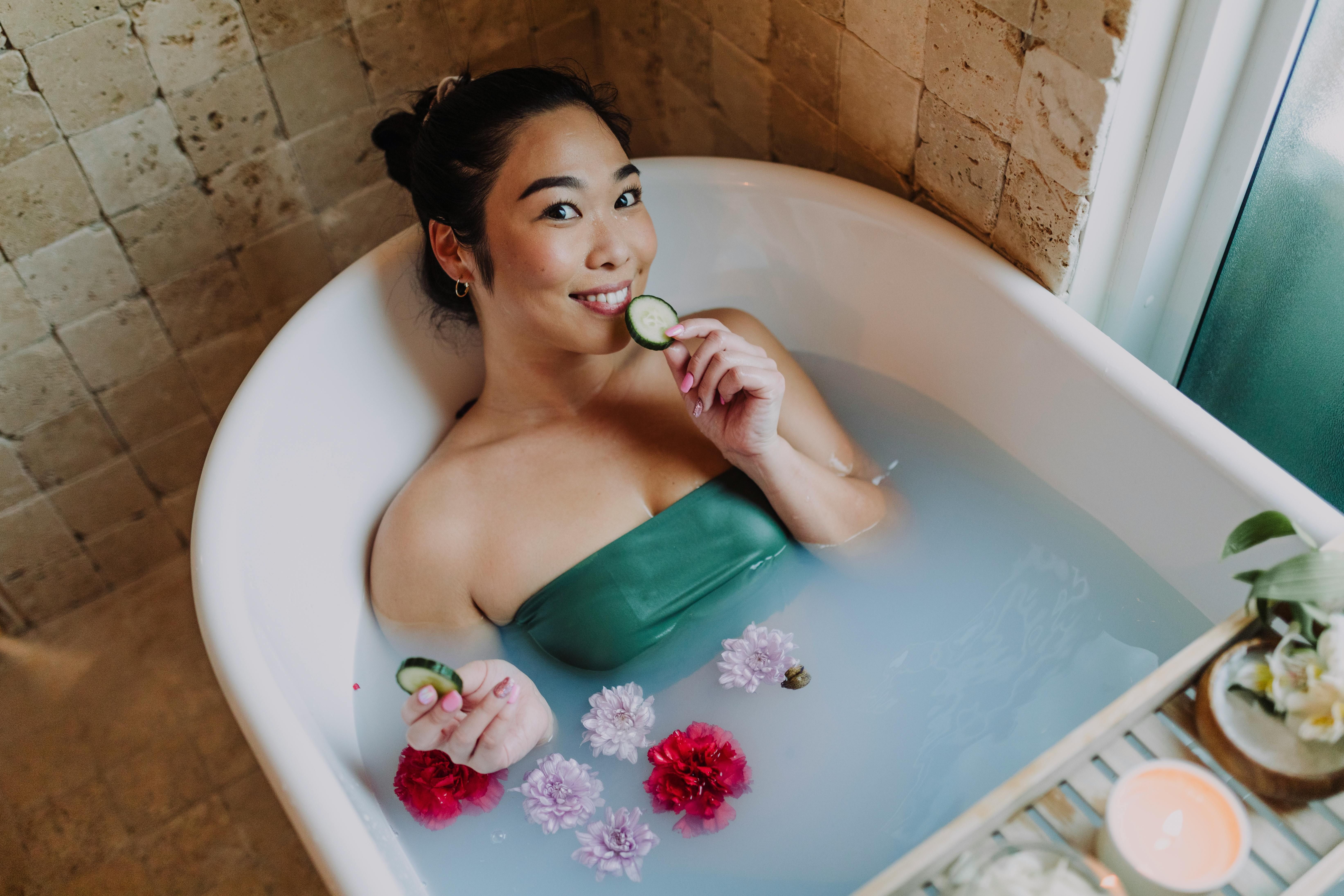 Relaxing Bath in a Hotel: Self-Care Tips for Women Maintaining Weight Loss on Business Trips A woman taking a relaxing bath in a hotel, practicing self-care to maintain her weight loss goals during a business trip.